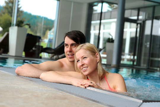 Couple in the swimmingpool/ Nature Spa Bathing Area /Seehotel Wiesler